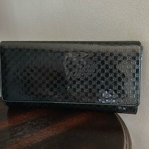 GUCCI
Black Micro-Guccissima Patent Leather Broadway Large Clutch Bag